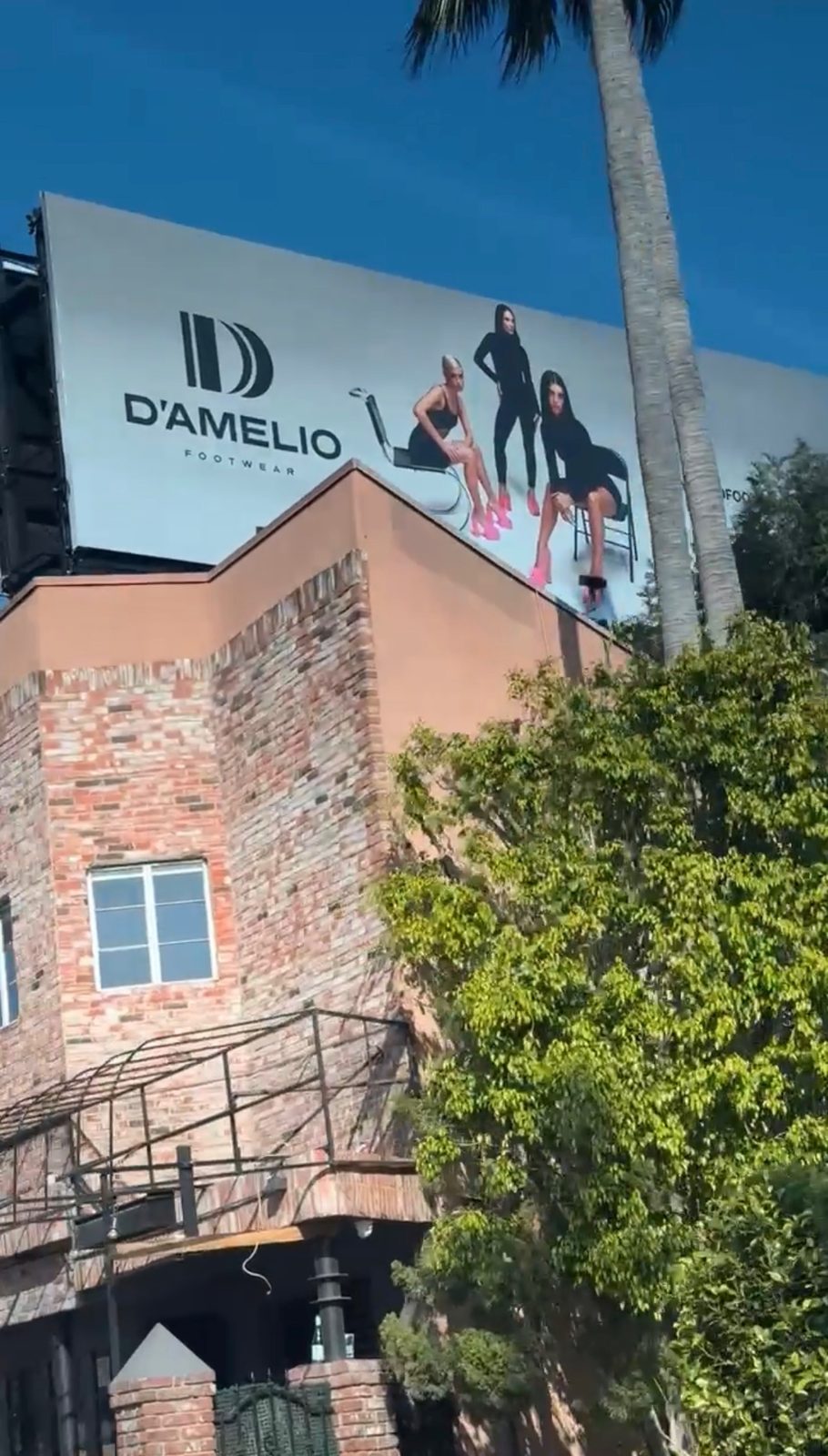 The D'Amelio Footwear billboard viewed from street level